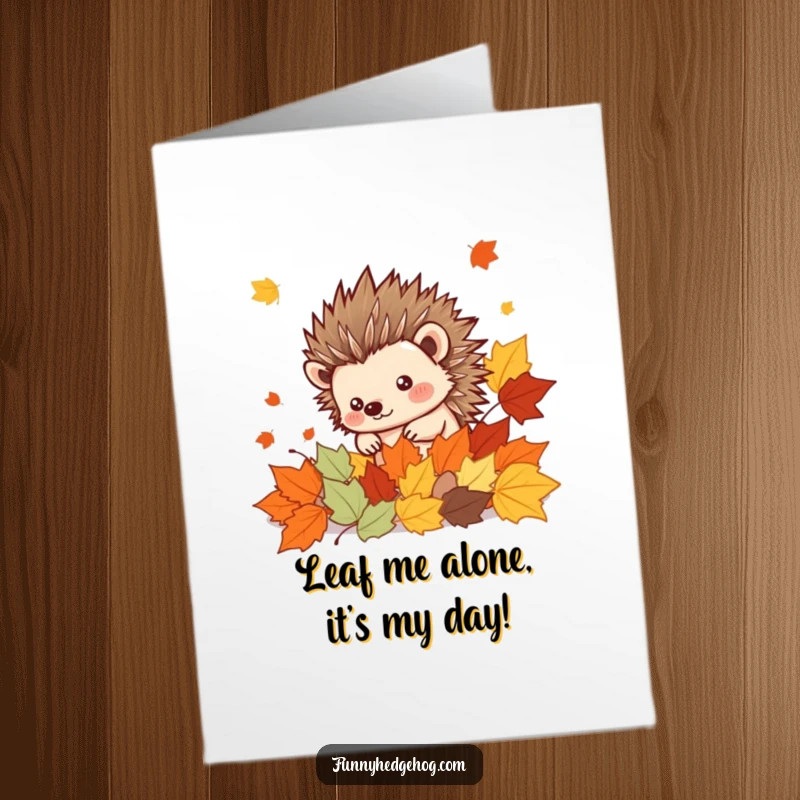 Funny Free Printable Hedgehog Birthday Card peeking from cheerful autumn leaves, a cute printable gift.