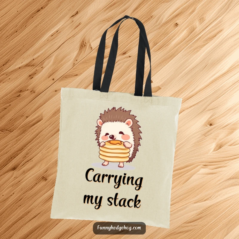 Funny tote bag featuring a determined hedgehog precariously balancing a stack of pancakes during a comical breakfast attempt.